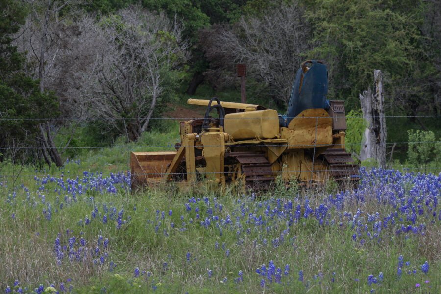 Old Rusty Bulldozer In Field Of Bluebonnets In Texas