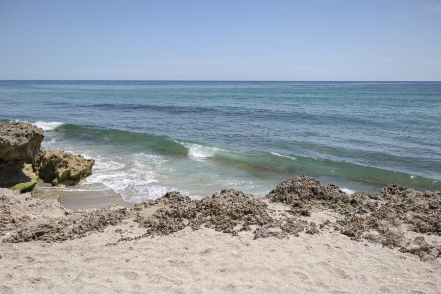 Waves Breaking On Beach With Rocks Along Atlantic Ocean