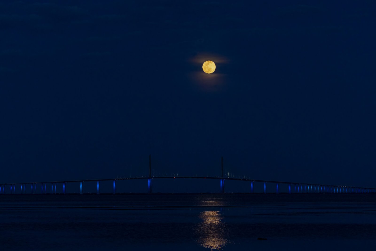 Super Moon Rising Above Lighted Sunshine Skyway Bridge