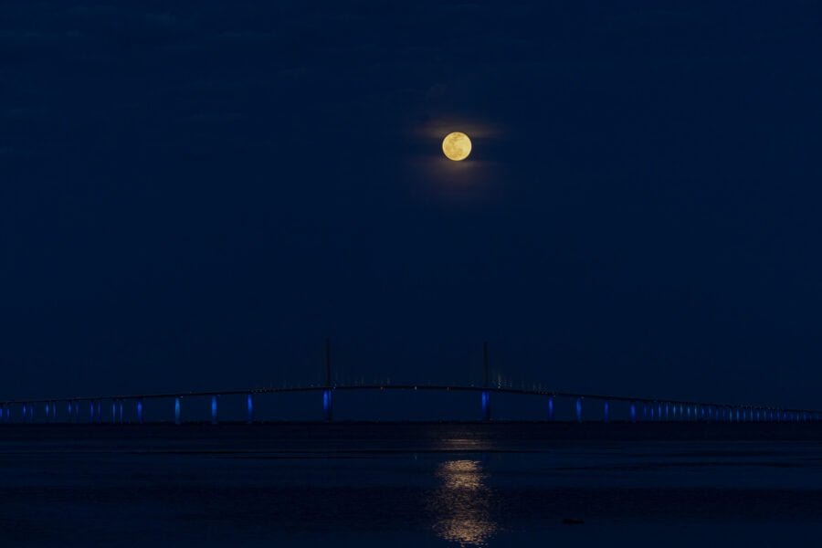 Super Moon Rising Above Lighted Sunshine Skyway Bridge