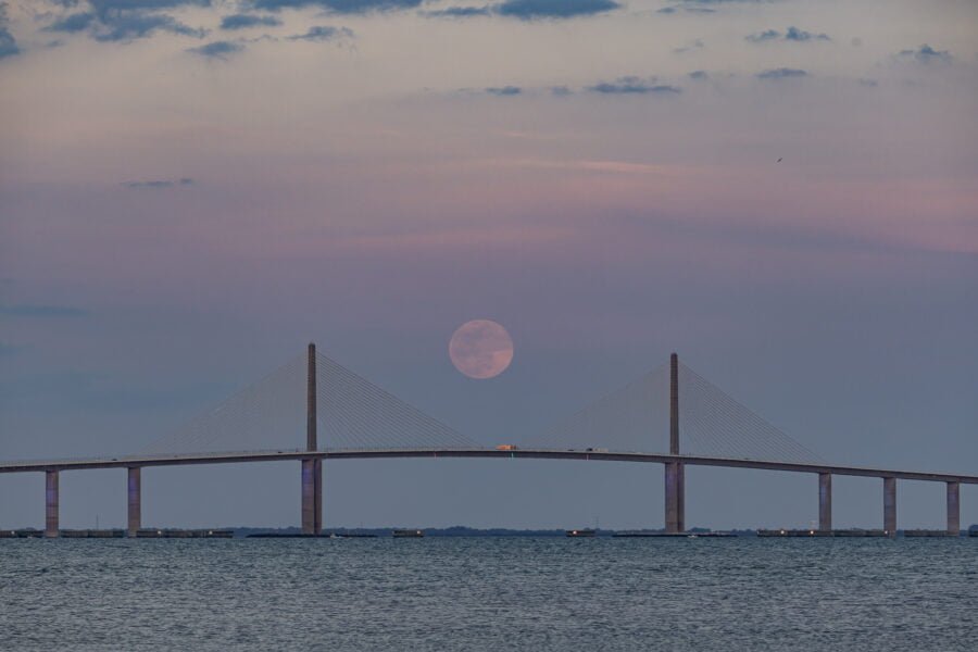 Super Moon Rising Between Spans Of Sunshine Skyway Bridge