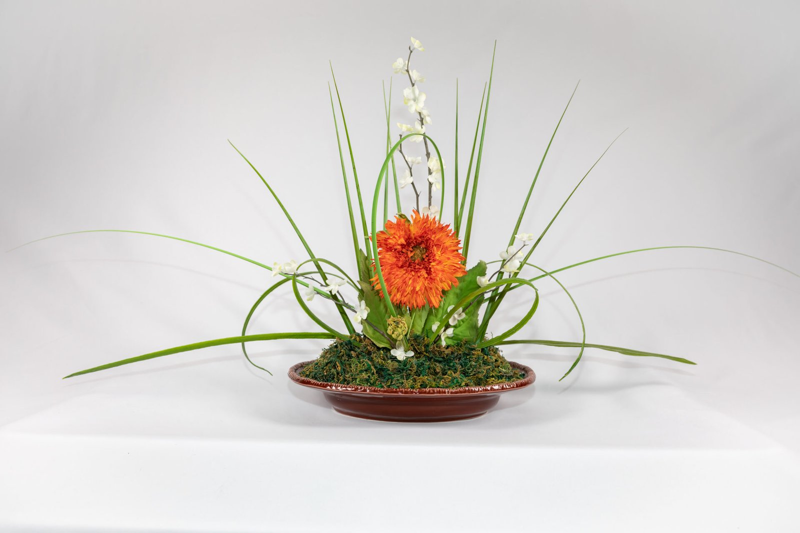 Large Brown Bowl With Orange And White Flowers And Grass Blades