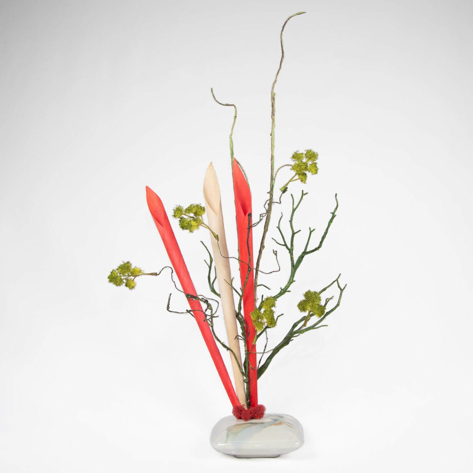 Small Flat White Vase With Red And White Trumpets And Green Flowers