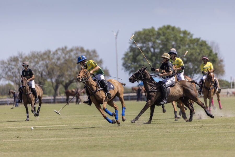 Group Of Polo Players Chasing Ball