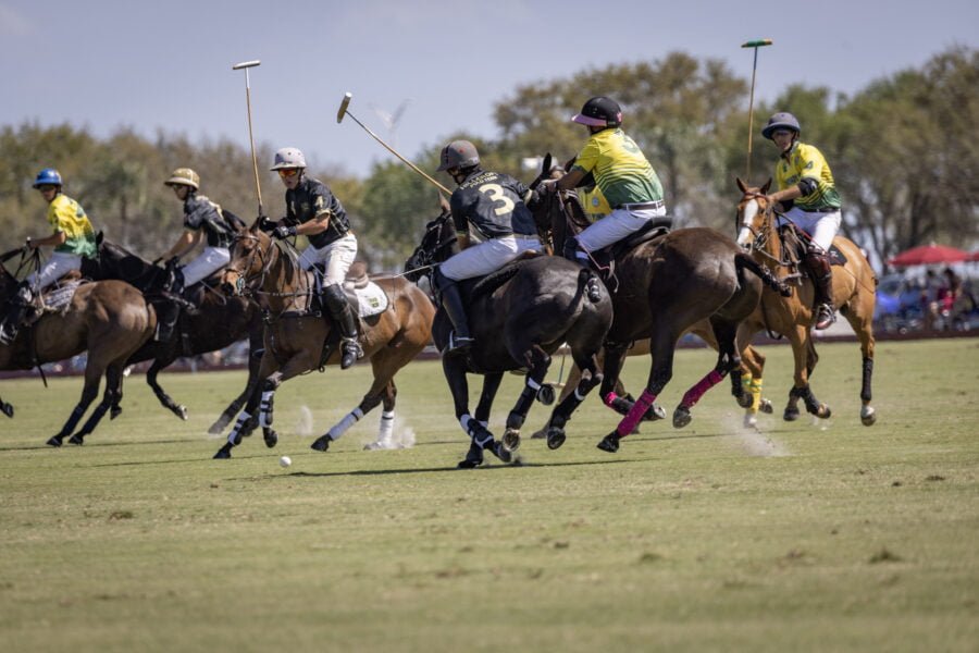 Group Of Polo Players Circling For Possession Of Ball