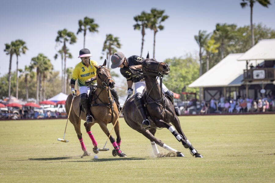 Two Polo Players Pivoting For Ball