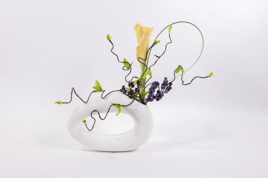 White Oval Vase With Yellow Blossom Purple Berries And Grass Bla